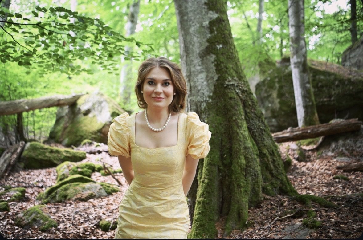 Karolina Bengtsson in a yellow dress in a beech forest
